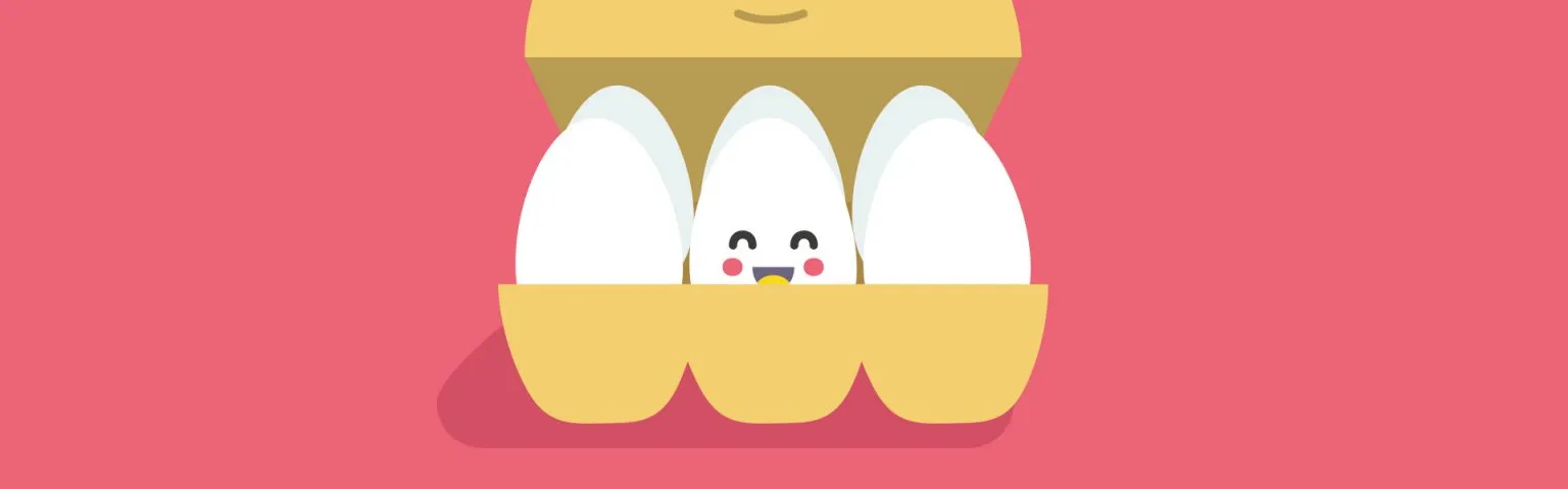 Illustration of an egg carton with four white eggs against a pink background. One of the eggs in the middle is cracked open slightly to reveal a smiling face inside, complete with eyes, rosy cheeks, and a beak.