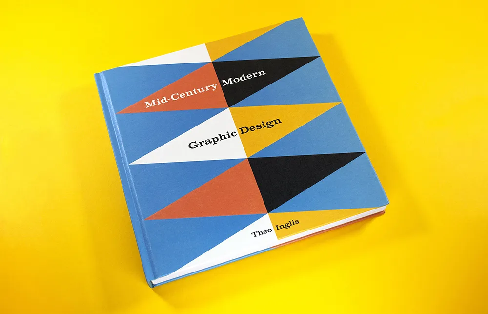 A book titled "Mid-Century Modern Graphic Design" by Theo Inglis is placed against a bright yellow background. The cover features a geometric pattern with triangular shapes in blue, orange, black, and white.