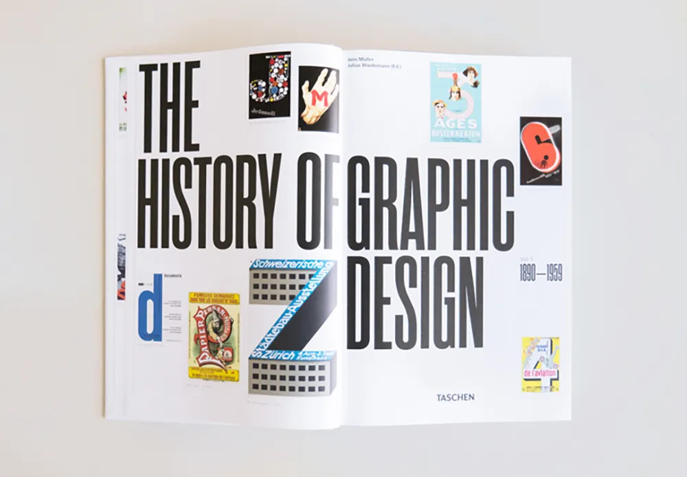An open book titled "The History of Graphic Design 1890-1959" by Taschen is shown. The pages contain various colorful graphic design samples surrounding the book's title, which is prominently displayed in large black text.