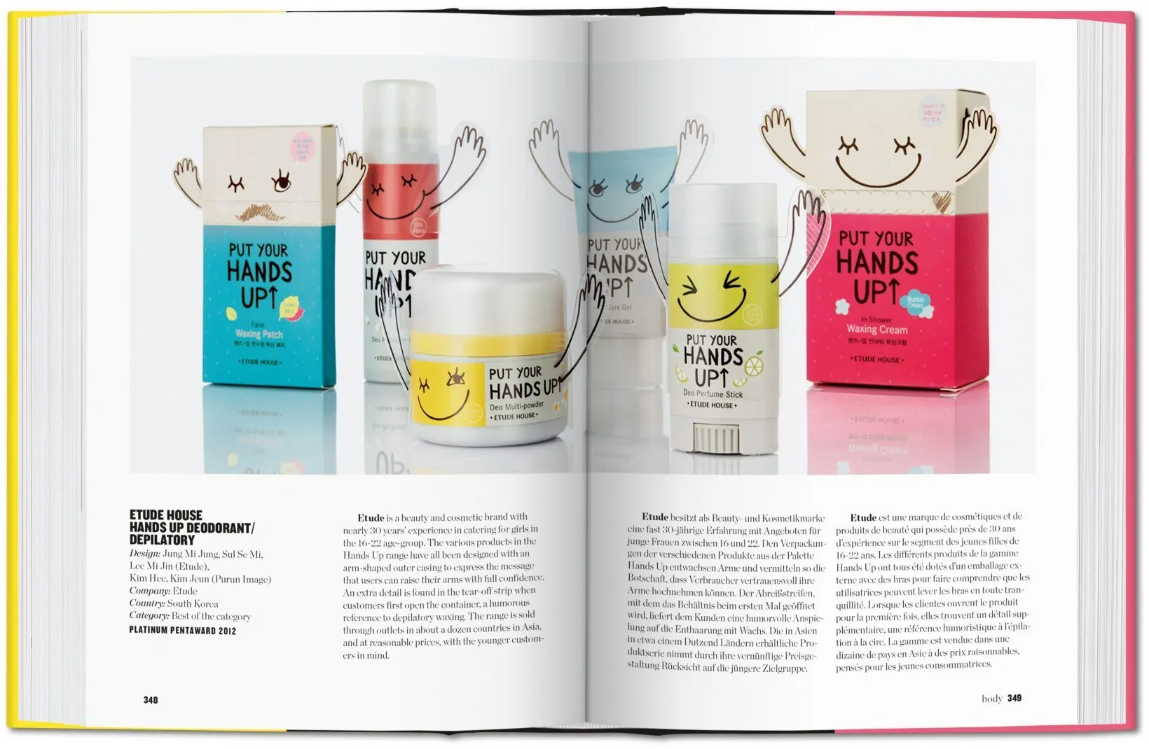 An open book displays a double-page spread showing skincare products from Etude House. The products, including jars and tubes, feature playful cartoon faces and arms raised, and are labeled "PUT YOUR HANDS UP." The background is white with product descrip